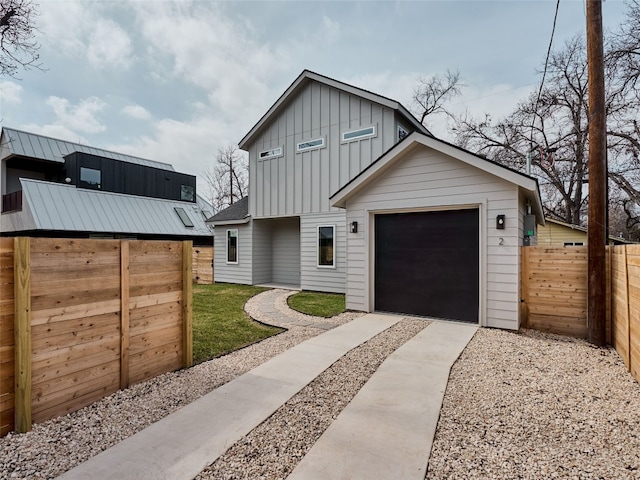 1002 Gullett St Unit 2, Austin, TX 78702 - view of front of house featuring board and batten siding, driveway, and a garage