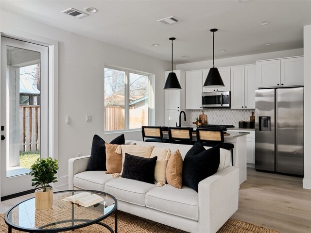 1002 Gullett St Unit 2, Austin, TX 78702 - living area with light wood-type flooring and recessed lighting