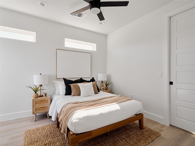 1002 Gullett St Unit 2, Austin, TX 78702 - bedroom featuring multiple windows, light wood-style flooring, baseboards, ceiling fan, and recessed lighting