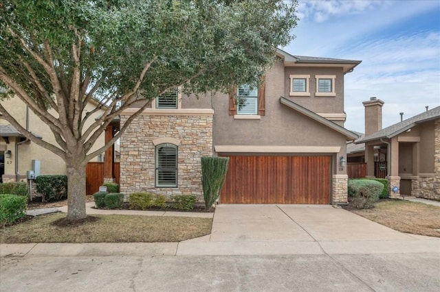 view of front facade with an attached garage, concrete driveway, and stucco siding