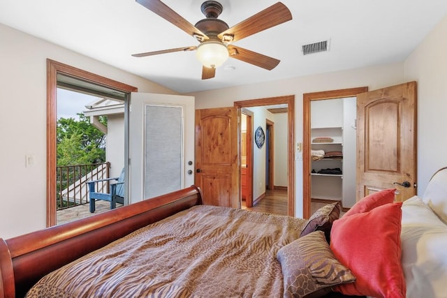 2900 Hi Mesa, Horseshoe Bay, TX 78657 - bedroom featuring wood finished floors, visible vents, a ceiling fan, a walk in closet, and access to exterior