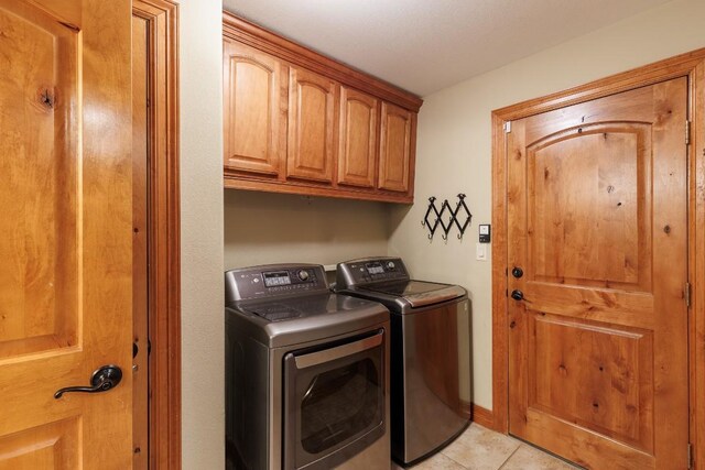 2900 Hi Mesa, Horseshoe Bay, TX 78657 - clothes washing area featuring cabinet space, washing machine and dryer, and light tile patterned floors