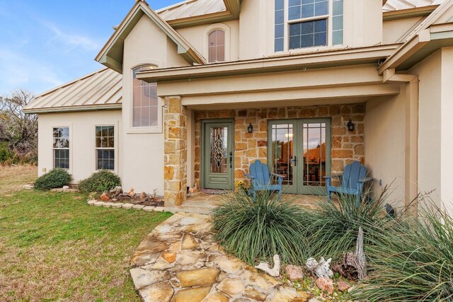 2900 Hi Mesa, Horseshoe Bay, TX 78657 - doorway to property featuring stone siding, stucco siding, french doors, and a yard