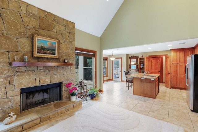 2900 Hi Mesa, Horseshoe Bay, TX 78657 - living room with light tile patterned floors, a fireplace, baseboards, and high vaulted ceiling