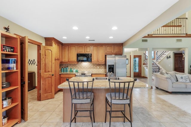 2900 Hi Mesa, Horseshoe Bay, TX 78657 - kitchen featuring a sink, stainless steel appliances, light tile patterned floors, and visible vents
