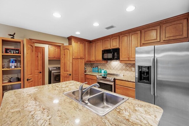 2900 Hi Mesa, Horseshoe Bay, TX 78657 - kitchen with a sink, visible vents, washer / dryer, appliances with stainless steel finishes, and tasteful backsplash
