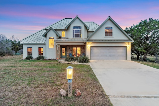 2900 Hi Mesa, Horseshoe Bay, TX 78657 - view of front facade with stucco siding, metal roof, concrete driveway, a front yard, and a standing seam roof