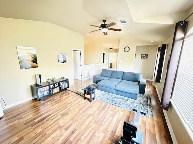 living area with lofted ceiling, light wood-type flooring, visible vents, and a ceiling fan