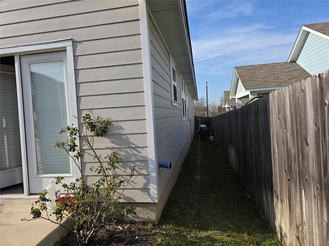 view of home's exterior with fence