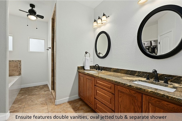 full bath with double vanity, a ceiling fan, a sink, and a garden tub