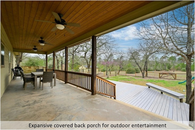 view of patio / terrace with a fenced backyard, outdoor dining space, ceiling fan, and a wooden deck