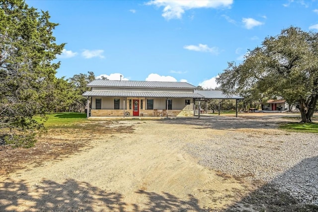 542 Stars And Stripes, Fischer, TX 78623 - view of front of home featuring stone siding, a porch, dirt driveway, and metal roof
