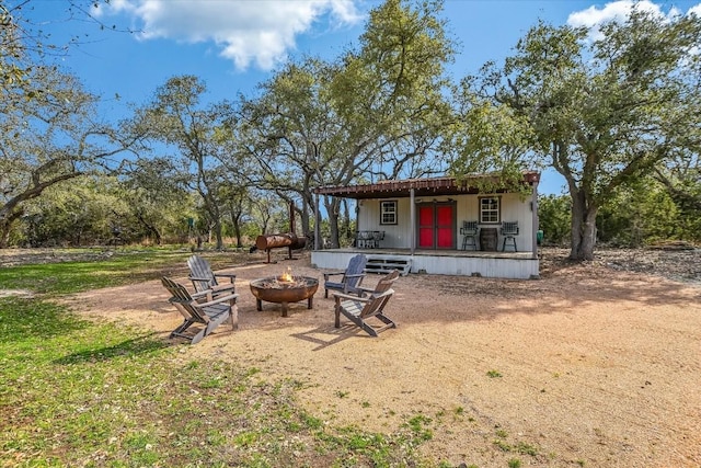 542 Stars And Stripes, Fischer, TX 78623 - rear view of house featuring an outdoor fire pit