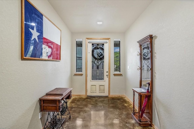 542 Stars And Stripes, Fischer, TX 78623 - entrance foyer featuring baseboards, concrete floors, and a textured wall