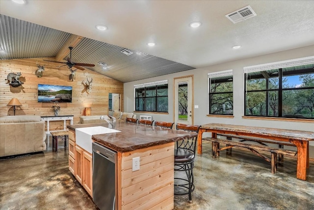 542 Stars And Stripes, Fischer, TX 78623 - kitchen featuring wooden walls, visible vents, finished concrete floors, and dishwasher