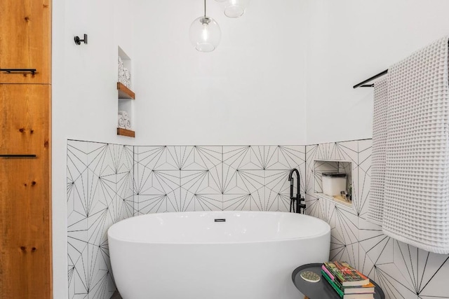 full bath with a freestanding bath and tile walls