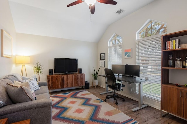 office featuring visible vents, ceiling fan, vaulted ceiling, wood finished floors, and baseboards