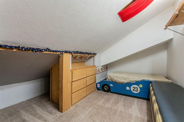 additional living space featuring light colored carpet, vaulted ceiling, and a textured ceiling