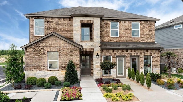 view of front of home with stone siding and brick siding