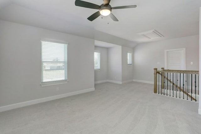 empty room with visible vents, light colored carpet, and baseboards