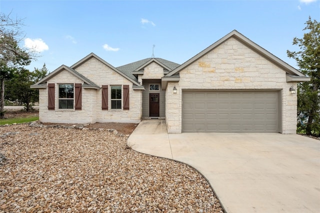 ranch-style home with a garage, concrete driveway, and a shingled roof