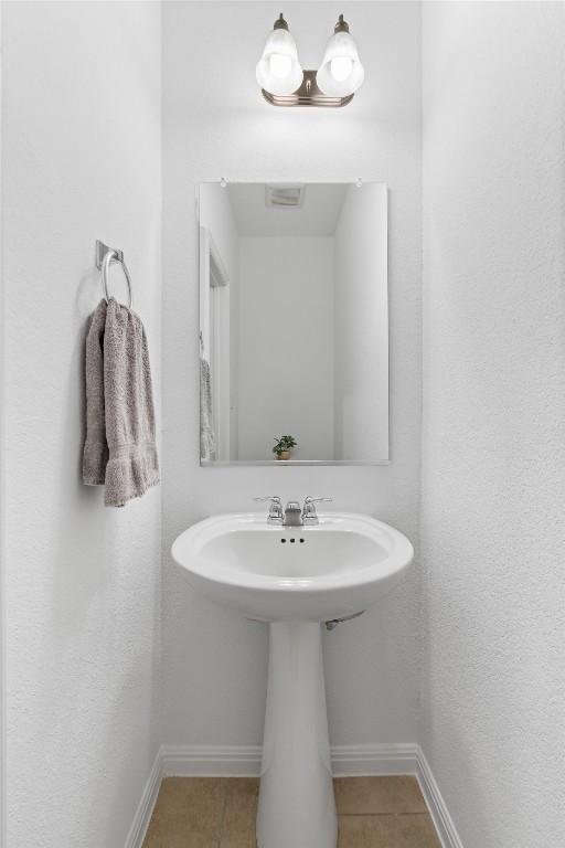 bathroom with tile patterned flooring and baseboards