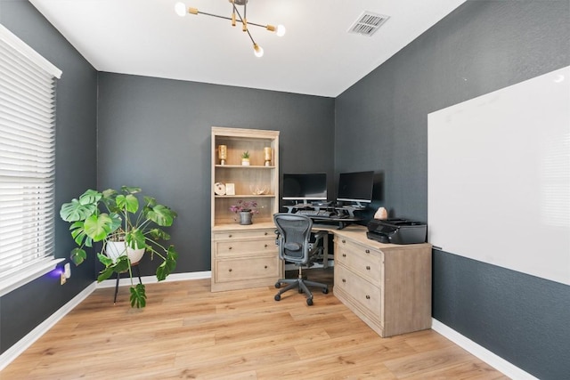 home office with light wood-style floors, visible vents, a notable chandelier, and baseboards