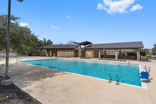 community pool featuring a gazebo and a patio area