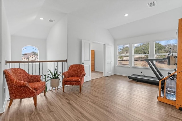 sitting room featuring visible vents, vaulted ceiling, wood finished floors, and recessed lighting