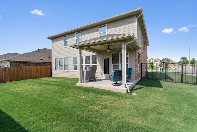 rear view of house featuring a lawn, a patio, a ceiling fan, and a fenced backyard