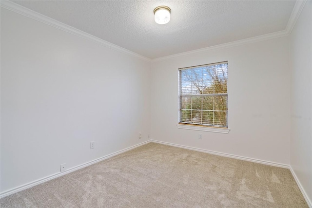 empty room featuring a textured ceiling, baseboards, crown molding, and light colored carpet