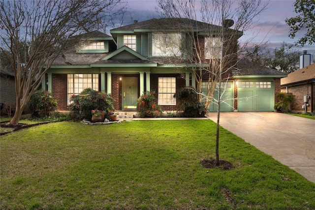 view of front of home with driveway, brick siding, a front lawn, and an attached garage