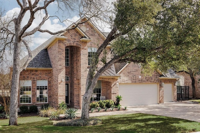 view of front facade featuring a garage, a shingled roof, concrete driveway, and brick siding