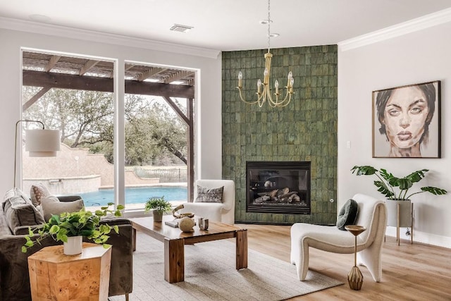 living area with plenty of natural light, visible vents, and crown molding