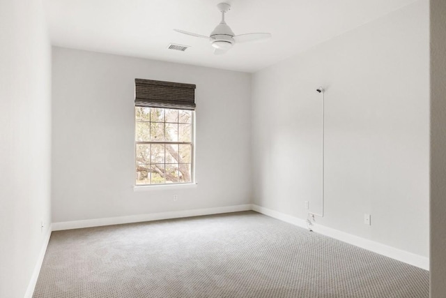 unfurnished room with visible vents, carpet floors, a ceiling fan, and baseboards