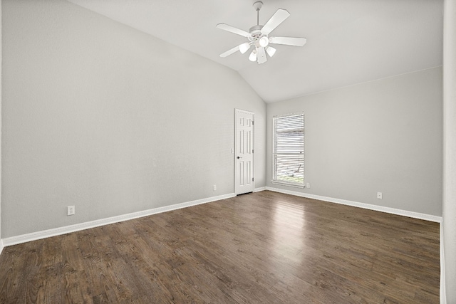 unfurnished room featuring dark wood-type flooring, vaulted ceiling, baseboards, and ceiling fan