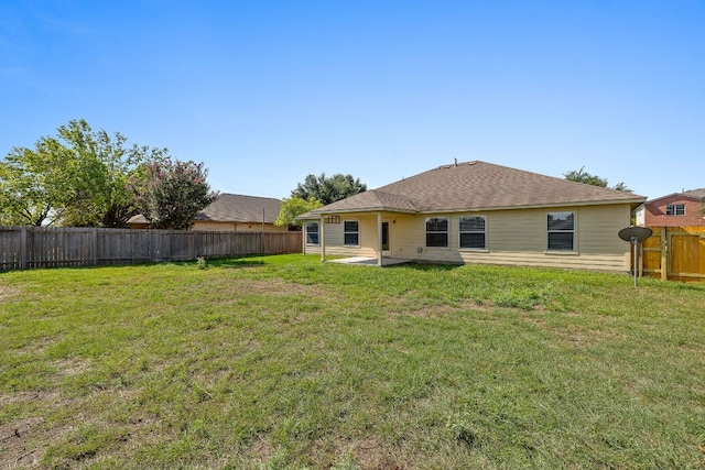 back of property featuring a patio, a lawn, and a fenced backyard