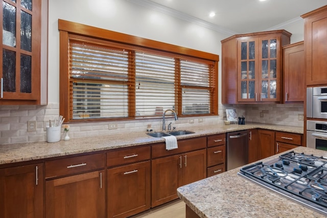 kitchen featuring stainless steel appliances, backsplash, glass insert cabinets, and crown molding