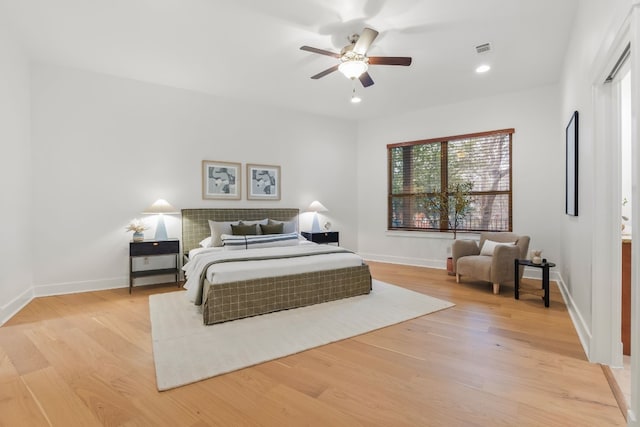 bedroom featuring light wood-type flooring, visible vents, and baseboards