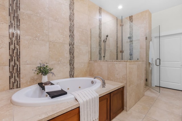 full bathroom with a whirlpool tub, tile patterned flooring, a shower stall, and tile walls