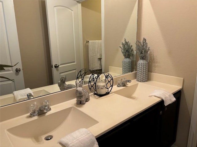 bathroom featuring a sink and double vanity