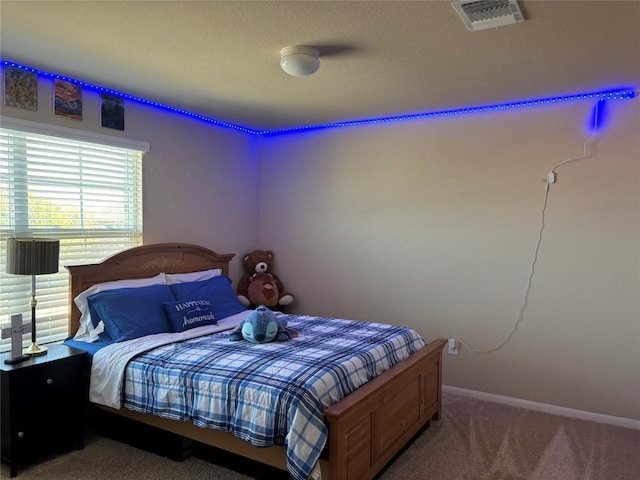 carpeted bedroom with baseboards and visible vents