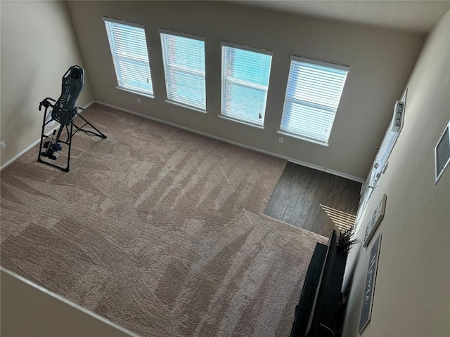 spare room featuring carpet and baseboards
