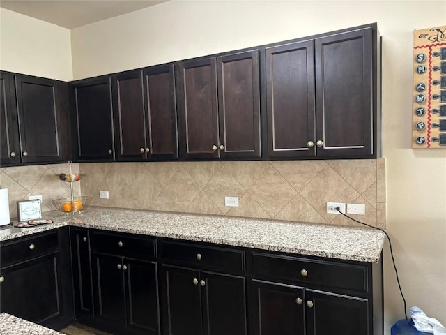 kitchen with tasteful backsplash and light stone countertops