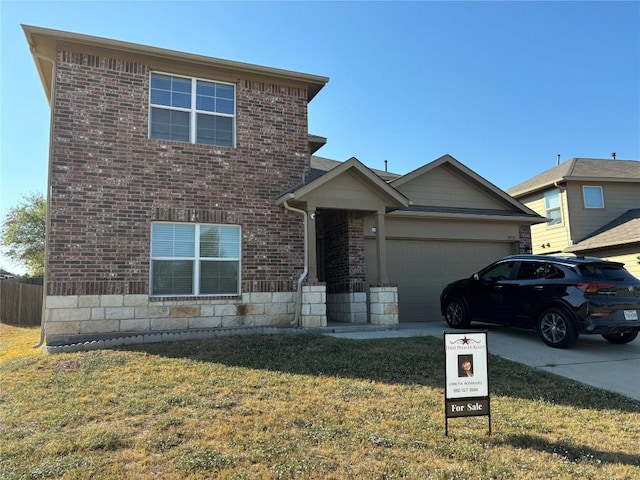view of front of home featuring concrete driveway, stone siding, an attached garage, a front yard, and brick siding