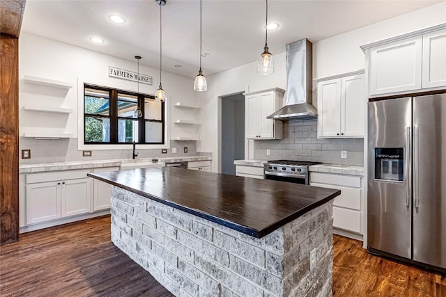 kitchen with white cabinets, wall chimney range hood, open shelves, and stainless steel appliances