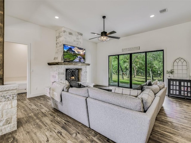 living room featuring a fireplace, visible vents, wood finished floors, and recessed lighting