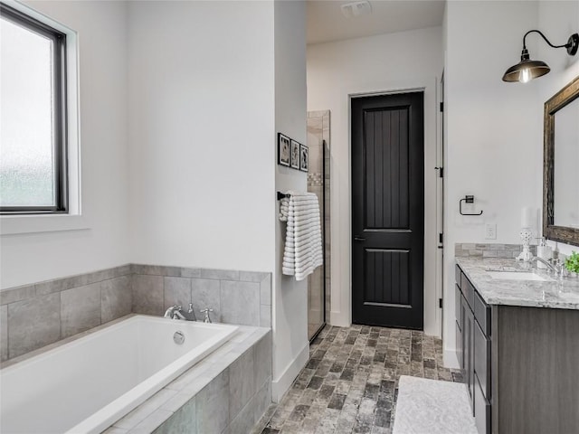 full bath with a shower stall, visible vents, a bath, and vanity