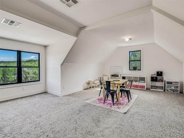 interior space featuring vaulted ceiling, visible vents, and baseboards