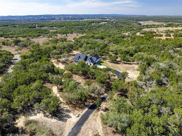 aerial view featuring a wooded view